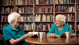 Photo of retirement village residents have tea in the library