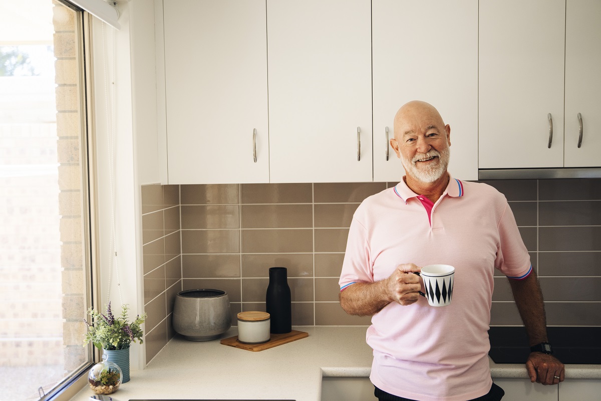 Older man relaxing in his kitchen