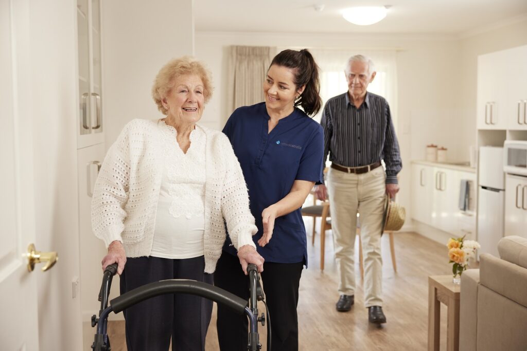 Older lady using a walker with a Home Care provider