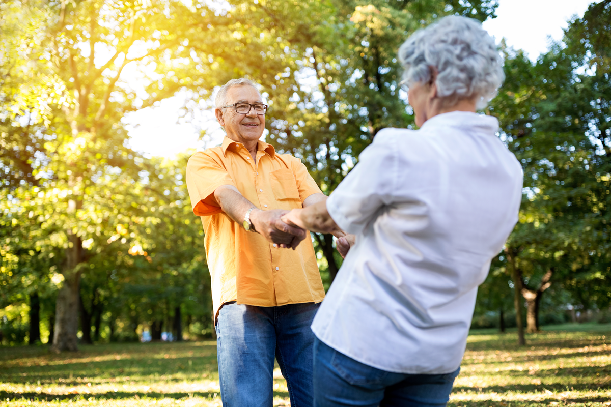Older couple dancing in the sunshine